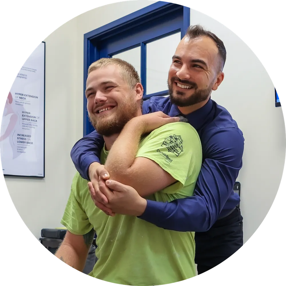 Dr. David Sedghi giving patient shoulder pain treatment