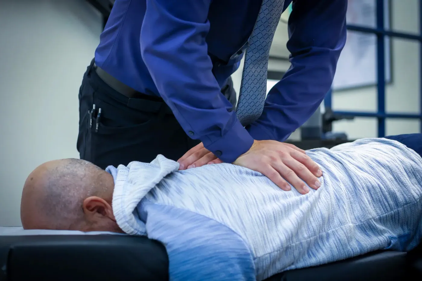 chiropractor giving the patient a back pain treatment