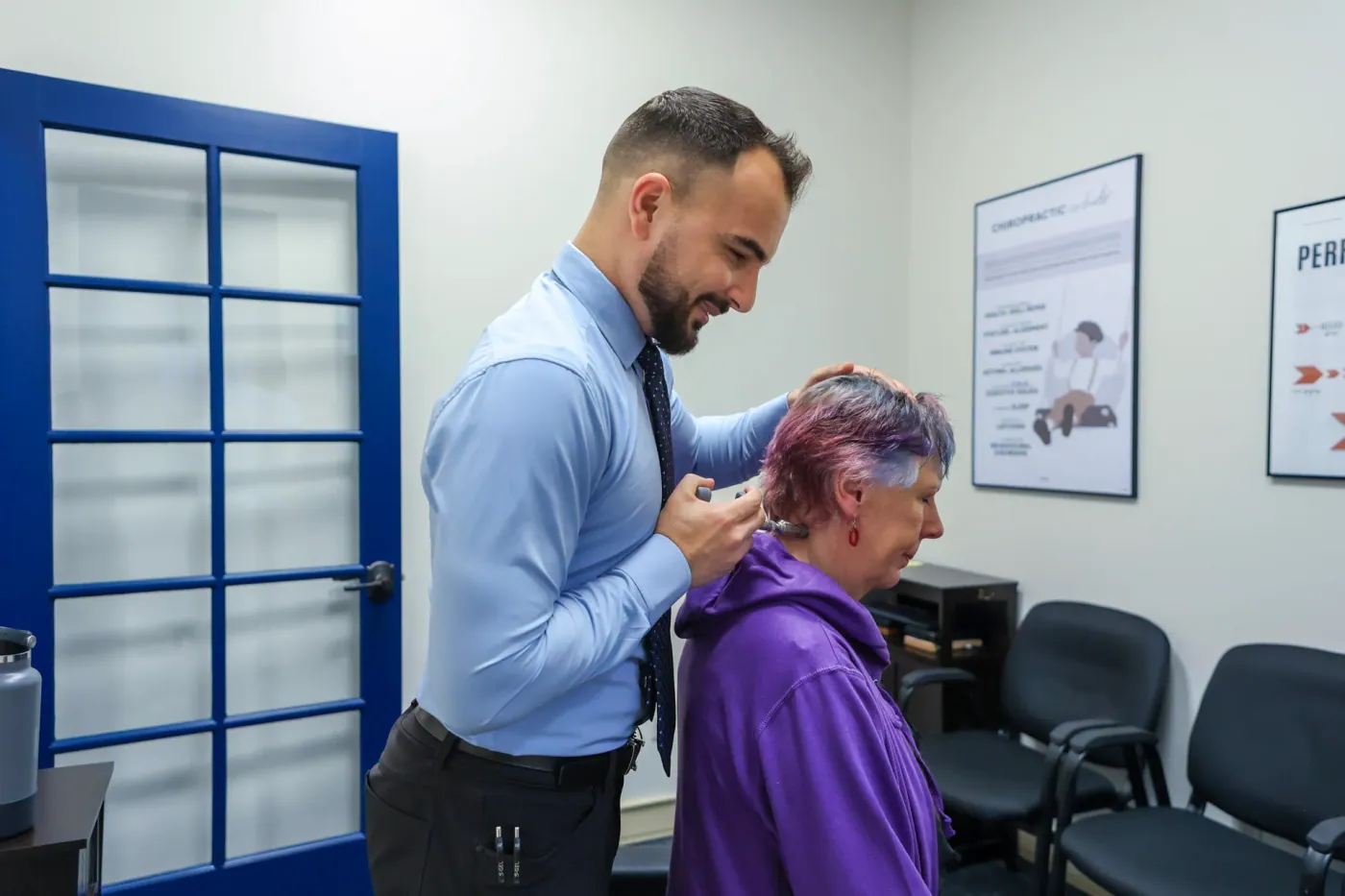 Dr. David Sedghi giving patient neck pain treatment