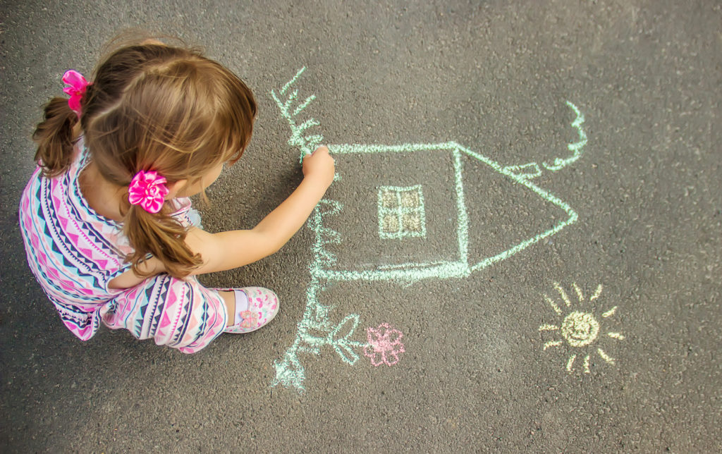 girl kid making art in street floor