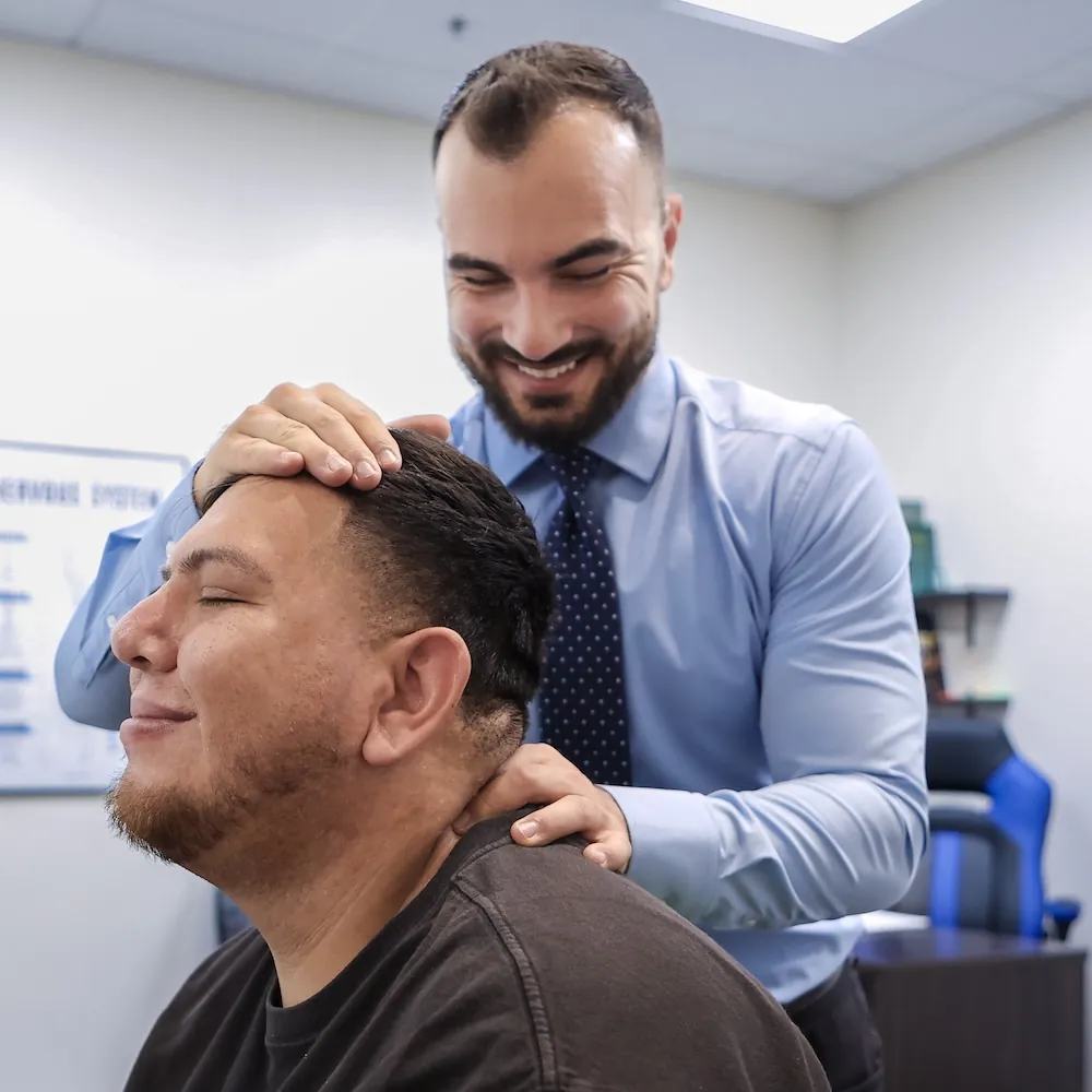 Dr. David Sedghi giving patient neck pain adjustment